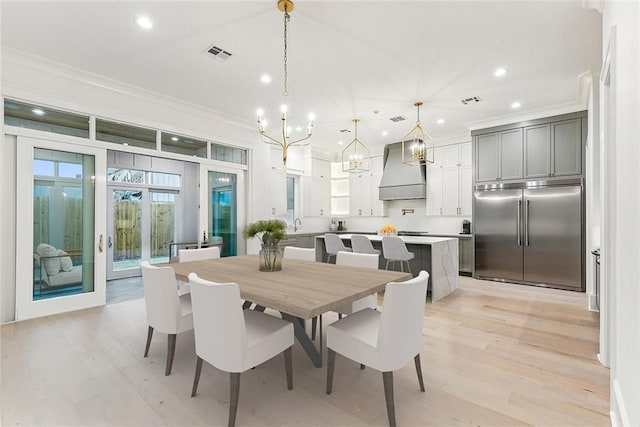 3705 Rue Emilion Dr, Metairie, LA 70002 - dining room with a chandelier, ornamental molding, recessed lighting, and light wood-style floors