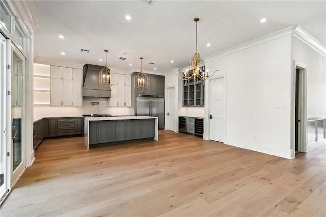 3705 Rue Emilion Dr, Metairie, LA 70002 - kitchen with premium range hood, built in fridge, a chandelier, crown molding, and recessed lighting