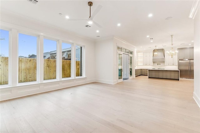 3705 Rue Emilion Dr, Metairie, LA 70002 - unfurnished living room with a ceiling fan, recessed lighting, light wood finished floors, and a chandelier