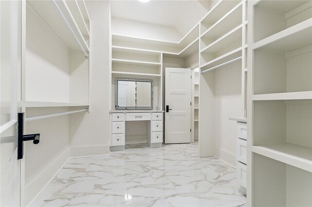 3705 Rue Emilion Dr, Metairie, LA 70002 - walk in closet featuring light marble finish floors and built in desk