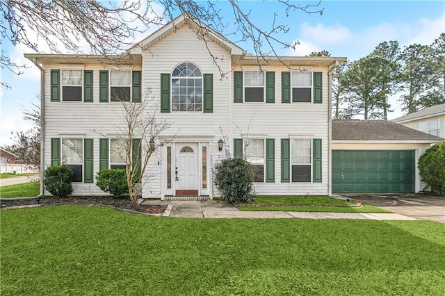 colonial-style house featuring a garage and a front lawn