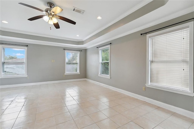 spare room with visible vents, baseboards, ornamental molding, light tile patterned floors, and a raised ceiling