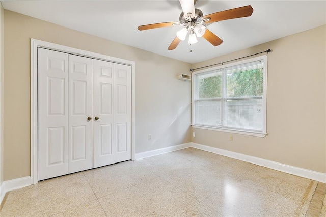 unfurnished bedroom featuring baseboards, light speckled floor, a closet, and a ceiling fan