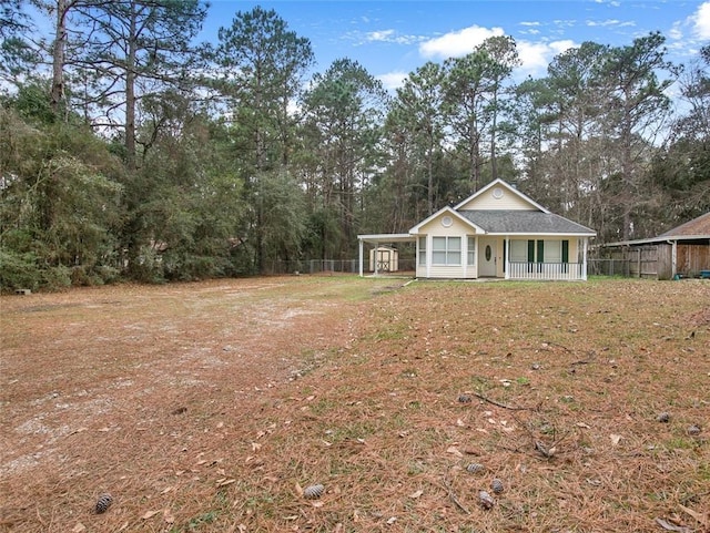 view of yard featuring a carport and covered porch