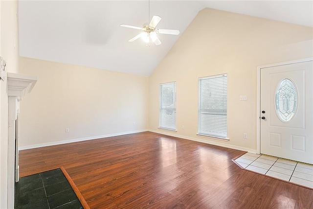 foyer with hardwood / wood-style floors, high vaulted ceiling, and ceiling fan