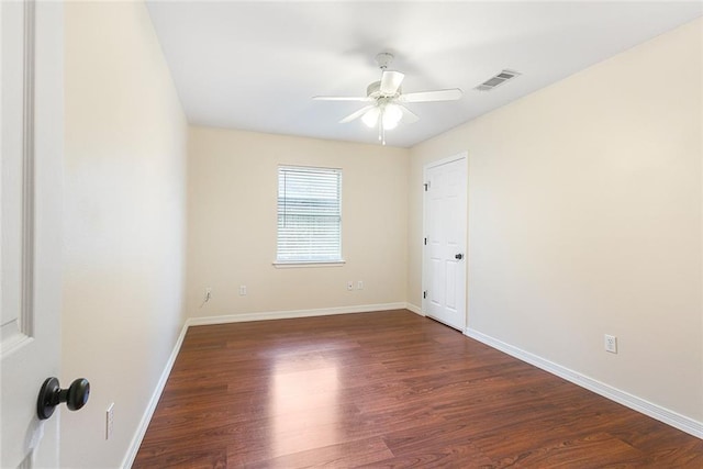 empty room with ceiling fan and dark hardwood / wood-style floors