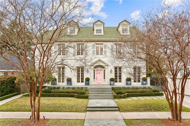 colonial-style house with a front lawn