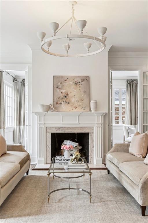 living room with ornamental molding, hardwood / wood-style floors, and a fireplace