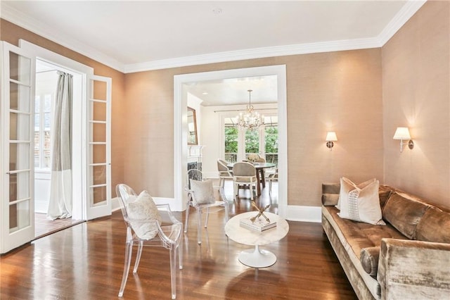 sitting room featuring dark hardwood / wood-style flooring, crown molding, french doors, and a chandelier