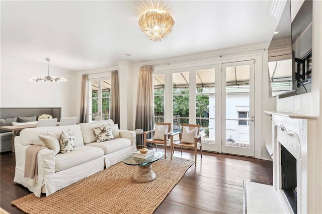 living room featuring dark wood-type flooring and an inviting chandelier