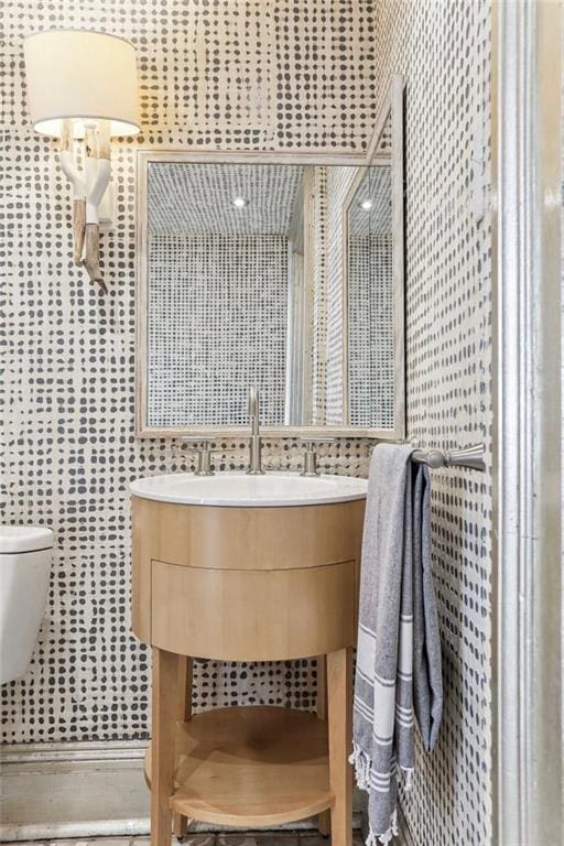 bathroom featuring vanity and toilet