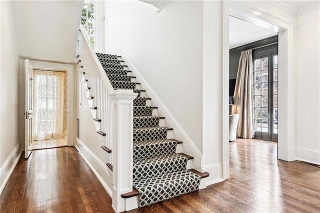 staircase with hardwood / wood-style flooring