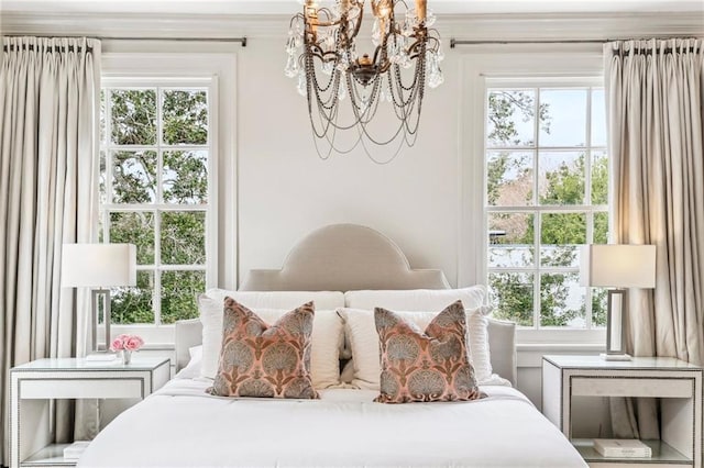 bedroom with multiple windows and a chandelier