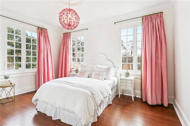 bedroom with multiple windows, ornamental molding, and dark wood-type flooring