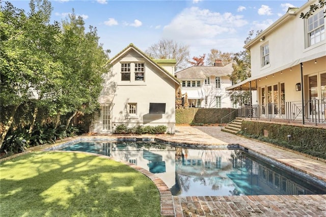 back of house with a yard and a patio area