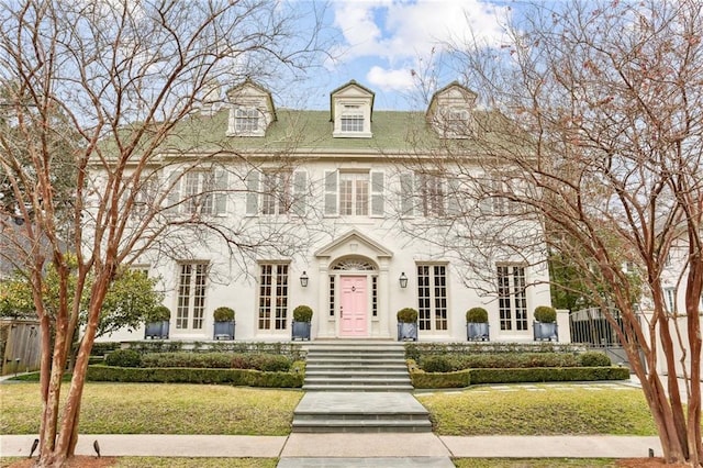 colonial-style house with a front lawn