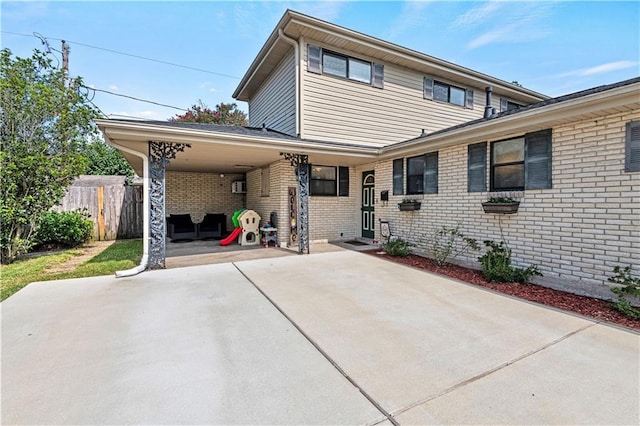 rear view of property with a carport