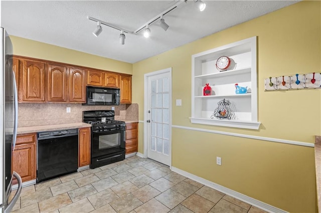 kitchen with built in features, brown cabinets, light countertops, a textured ceiling, and black appliances