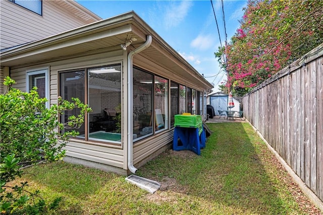 exterior space with a fenced backyard and a sunroom