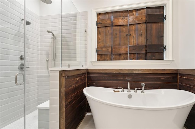 bathroom featuring separate shower and tub