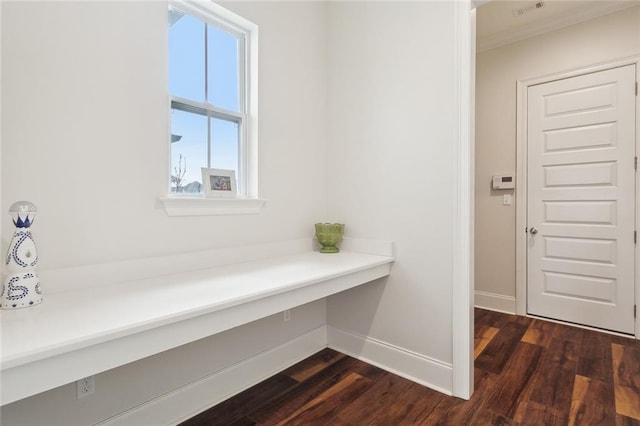 interior space featuring crown molding and dark hardwood / wood-style flooring