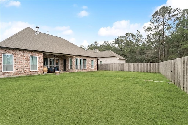 rear view of house with a lawn