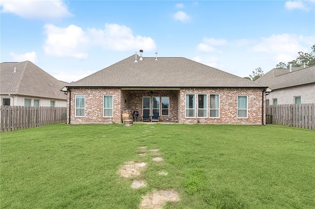 back of house featuring a yard