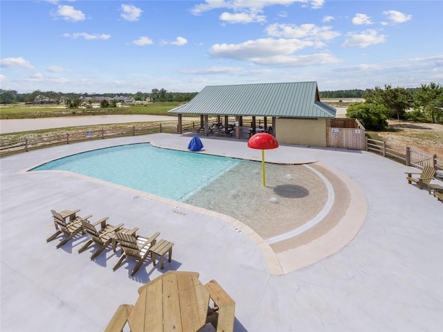 view of swimming pool featuring a patio area