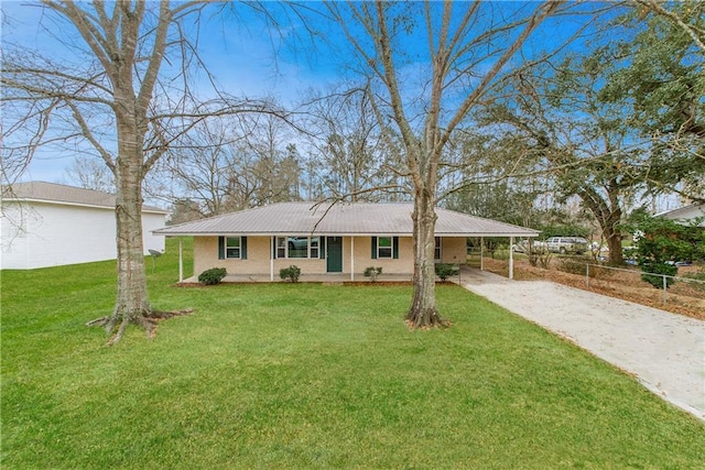 ranch-style house featuring a carport, a front yard, and covered porch