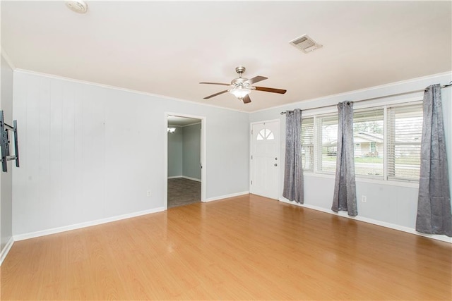 unfurnished room with hardwood / wood-style flooring, crown molding, and ceiling fan