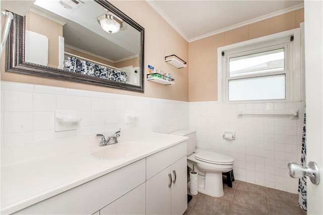 bathroom with toilet, tile walls, ornamental molding, vanity, and tile patterned flooring