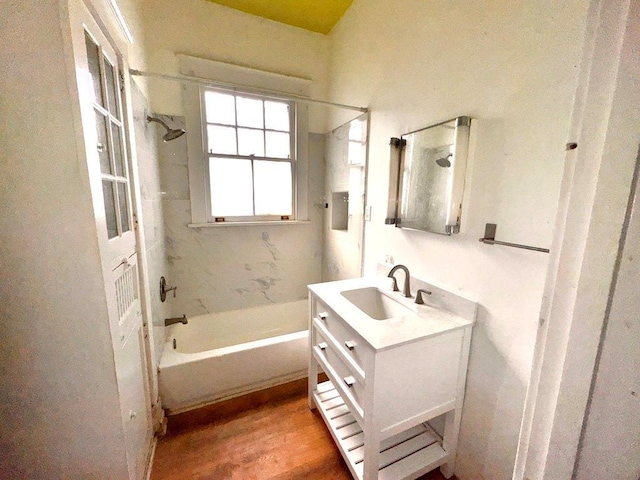 bathroom featuring vanity, hardwood / wood-style flooring, and tiled shower / bath combo