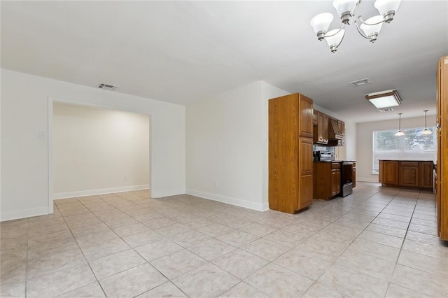 unfurnished living room with light tile patterned floors and a notable chandelier