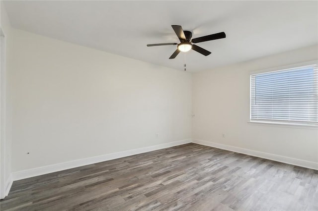 spare room with hardwood / wood-style floors and ceiling fan