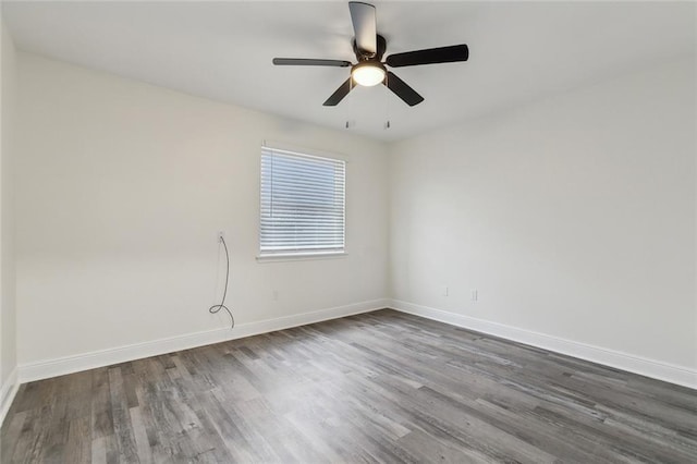 unfurnished room with ceiling fan and dark hardwood / wood-style flooring