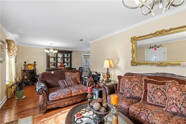 living room featuring a notable chandelier, wood-type flooring, and ornamental molding