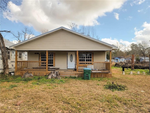 bungalow with covered porch and a front yard