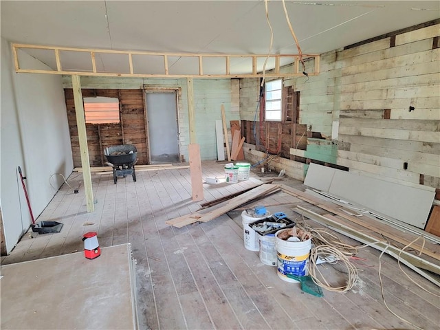 miscellaneous room with wooden walls and wood-type flooring