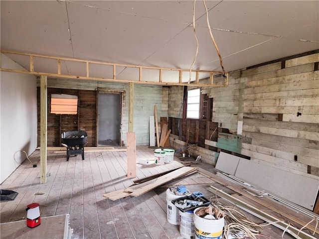 misc room with wooden walls and wood finished floors