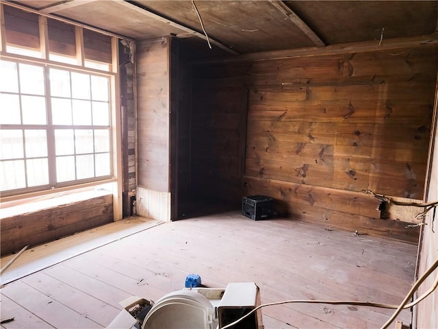 spare room with wood walls and hardwood / wood-style flooring