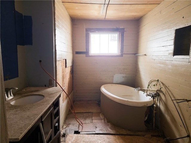 bathroom with a freestanding bath and vanity