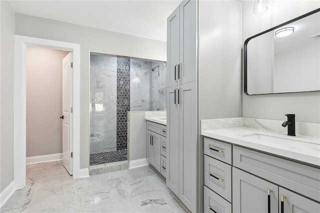 bathroom with tiled shower and vanity