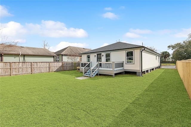 back of property with a deck and a lawn