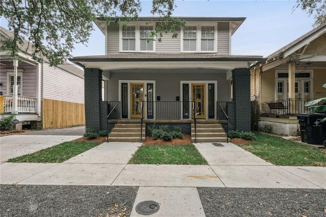 traditional style home with covered porch and brick siding