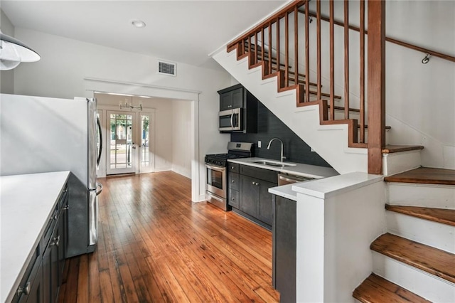 kitchen featuring french doors, visible vents, appliances with stainless steel finishes, a sink, and dark cabinets