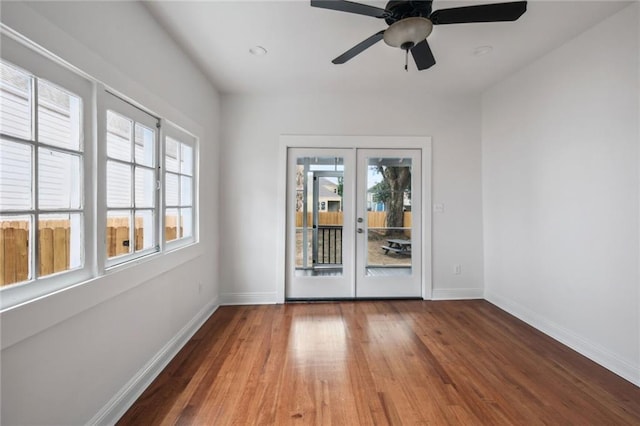 unfurnished room with hardwood / wood-style floors, ceiling fan, and french doors