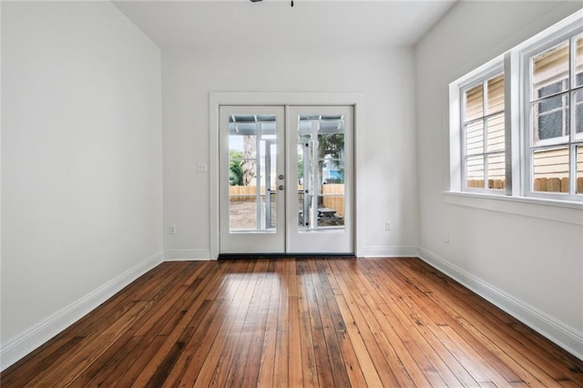 spare room featuring french doors and wood-type flooring