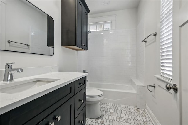 full bathroom with vanity, tiled shower / bath combo, tile patterned floors, and toilet