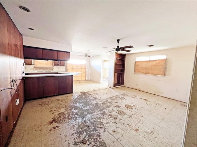 kitchen featuring ceiling fan and kitchen peninsula