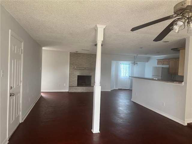 unfurnished living room featuring dark wood-type flooring, a fireplace, a textured ceiling, and ceiling fan